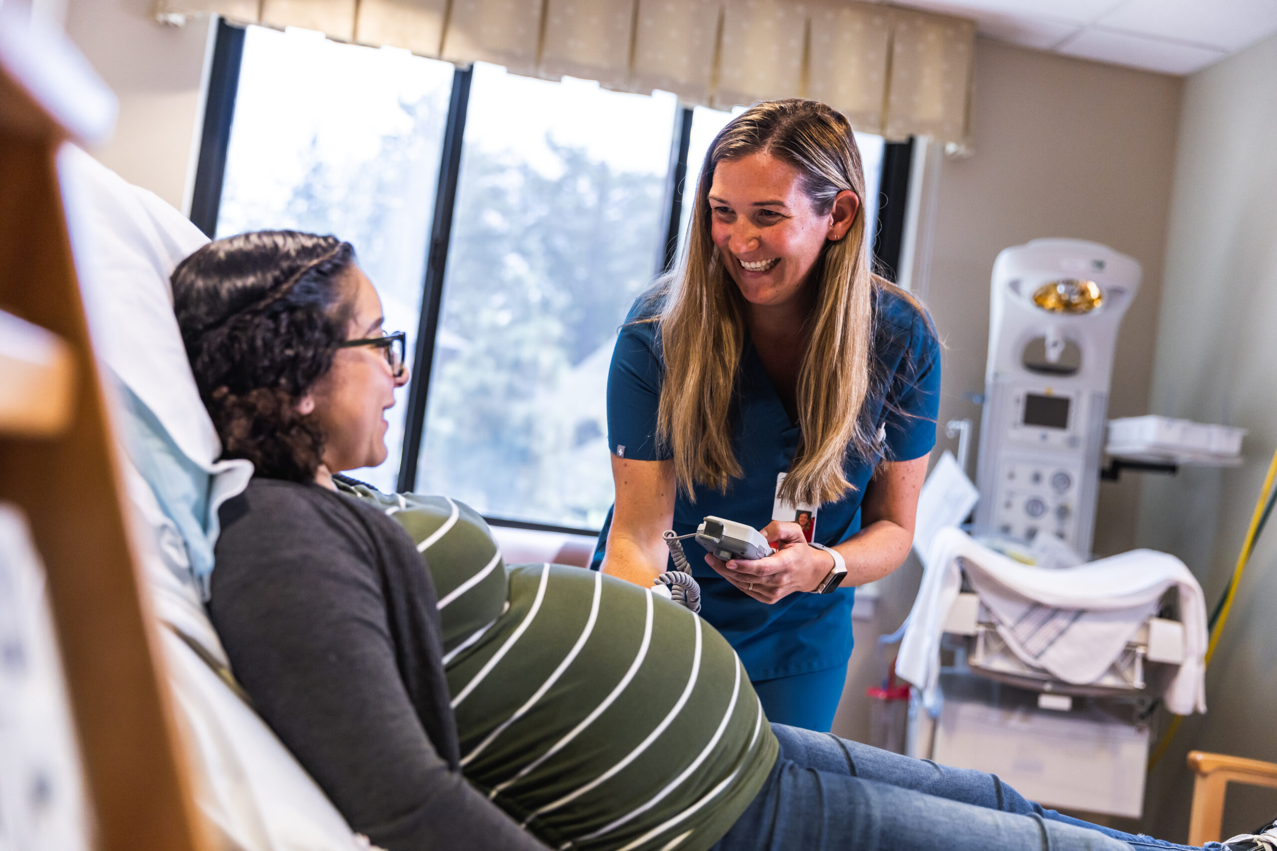 Woman getting her pregnant belly checked in a hospital setting